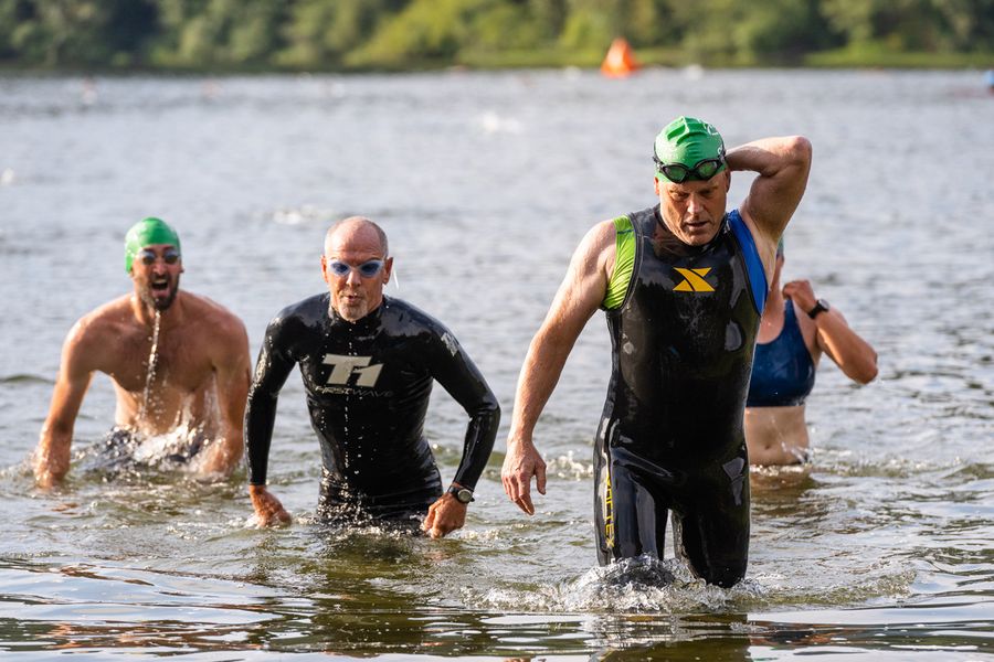 Triathletes running out of Lake Padden after the swim